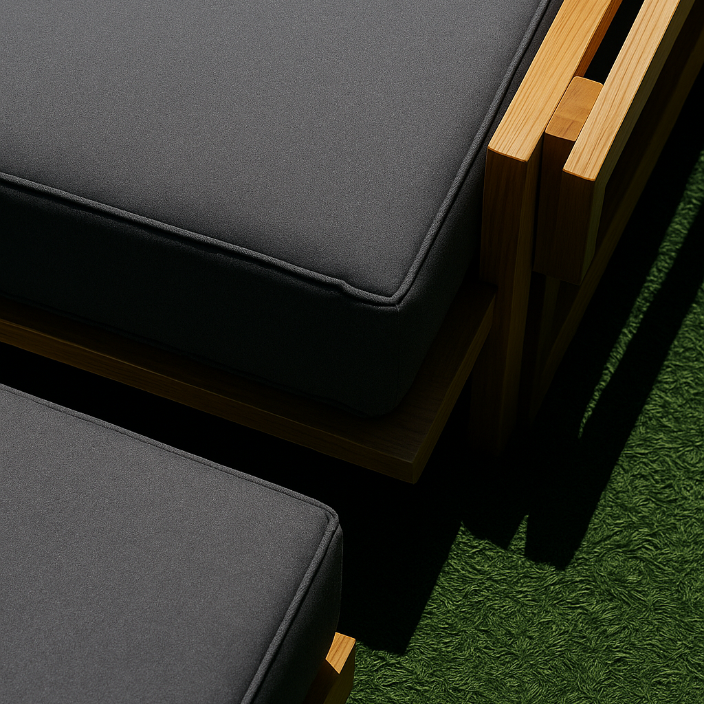 Gray cushions on a wooden outdoor furniture set against a green grass background