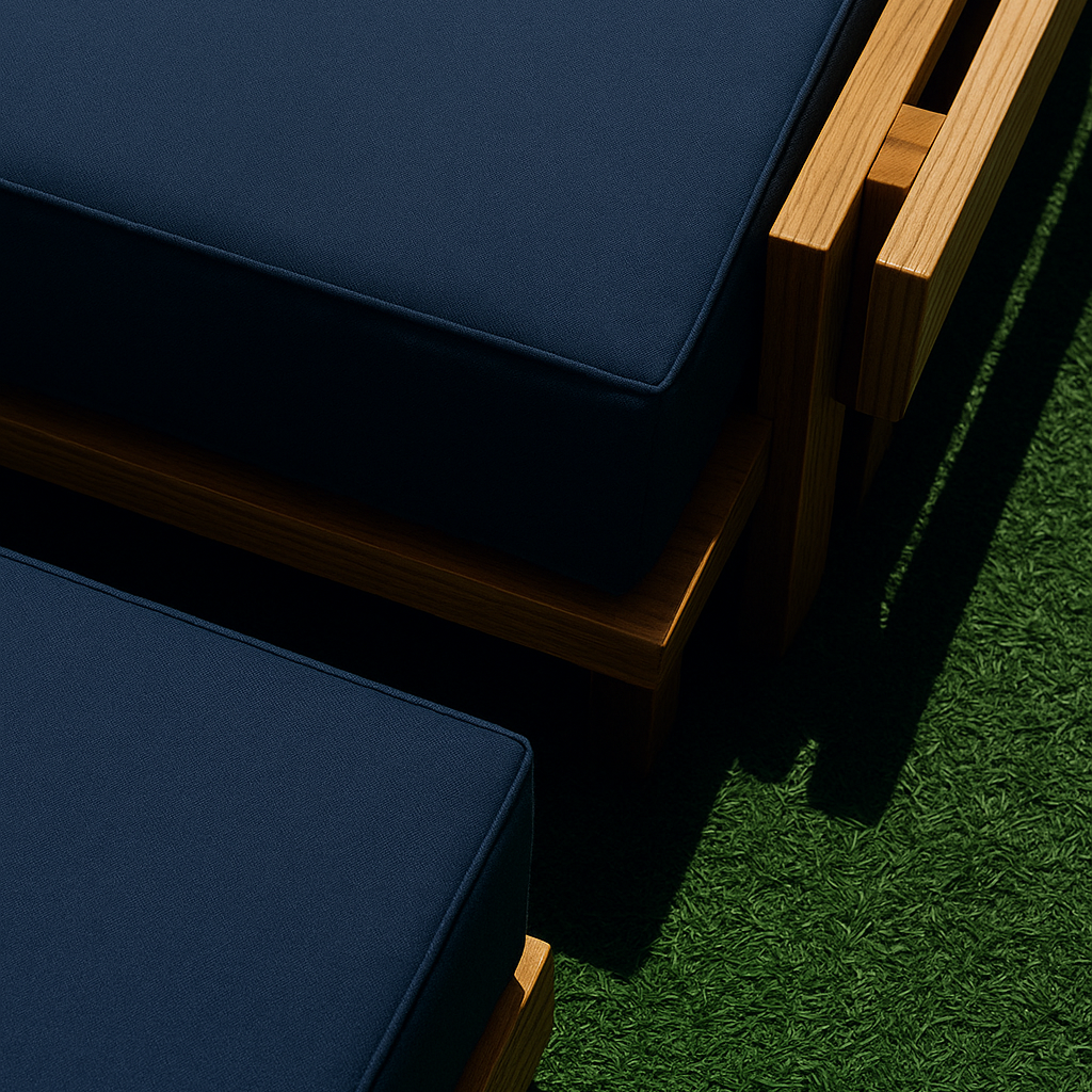 Navy cushions on wooden furniture against a green grass background