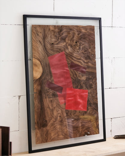 vibrant painting with red chair-inspired shapes on warm walnut veneer.