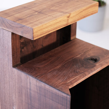 Walnut and teak DuoRest Side Table with sturdy frame and drawer, offering style and utility.