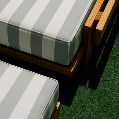 Striped outdoor cushions on wooden furniture with a green grass background