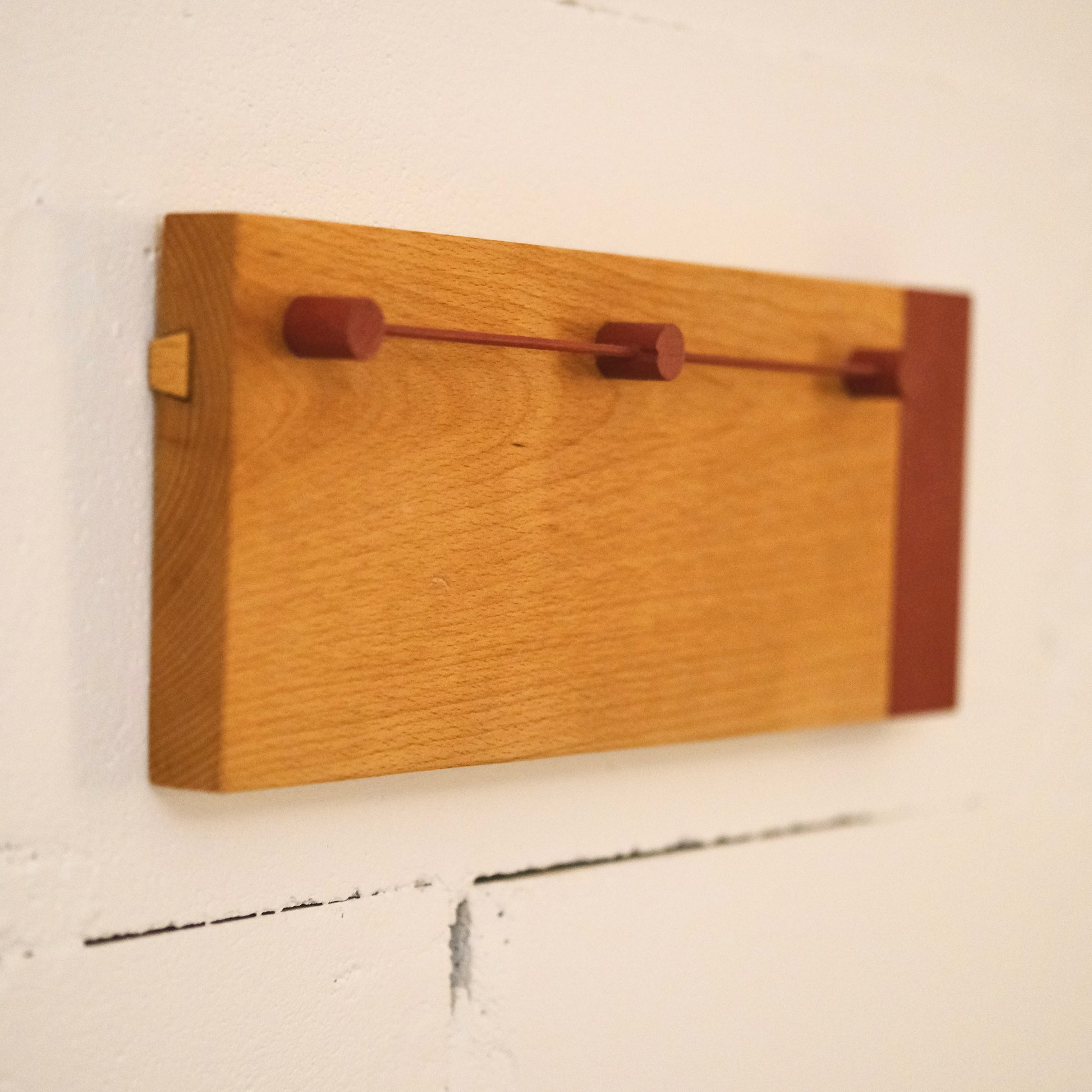 Wall-mounted sunglasses holder in premium wood with minimalist design for stylish organization